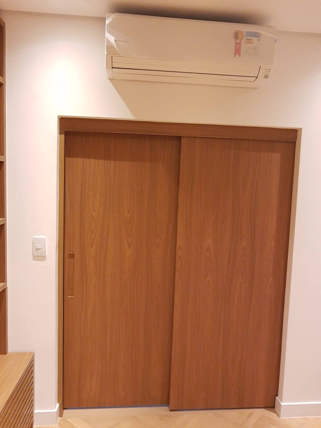 Guarda-roupa planejado com porta de correr em madeira, projeto da Prado Marcenaria